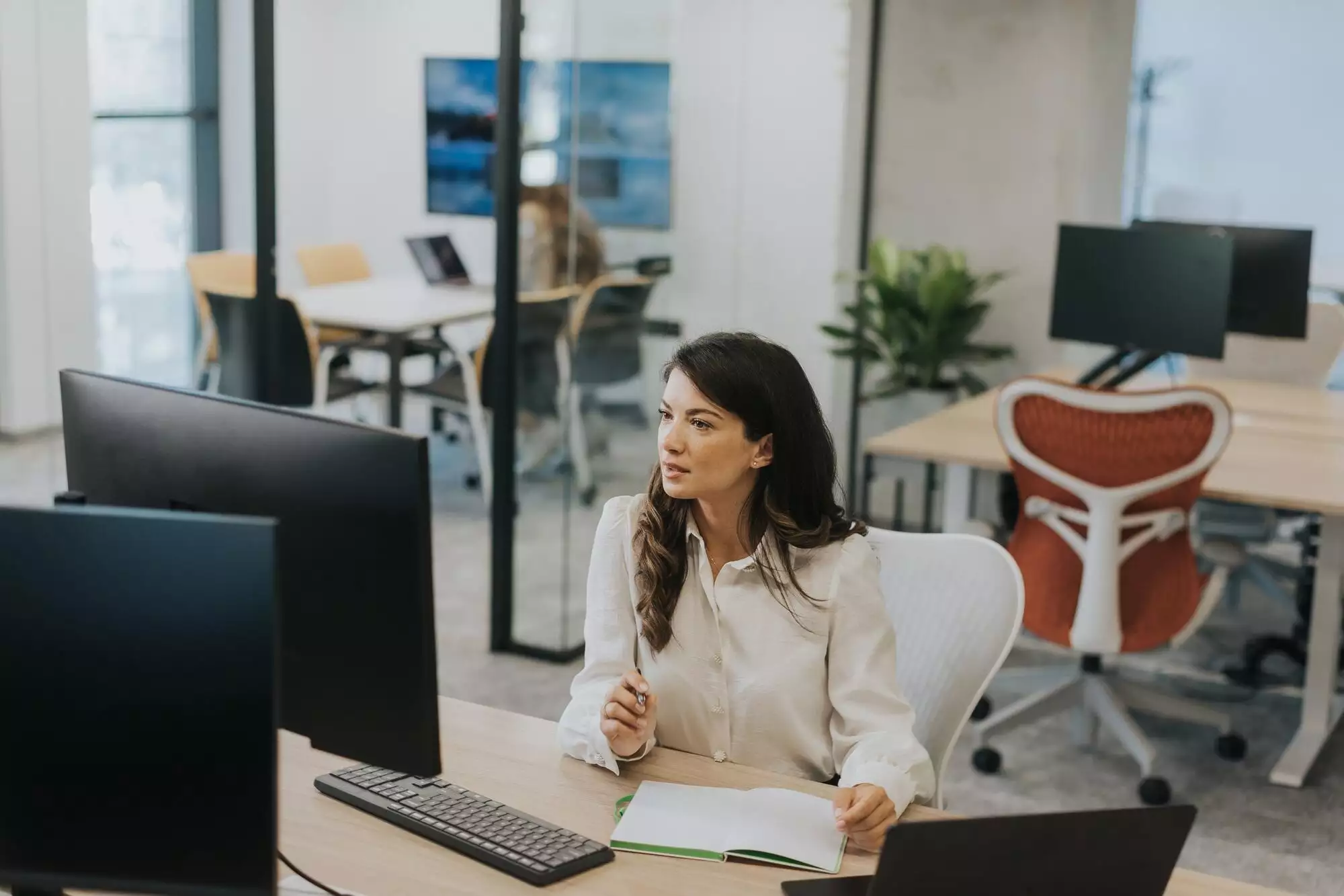 Young business woman working on laptop in the modern office